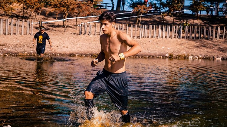 un homme sportif court dans l'eau